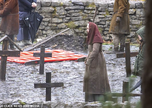 The fashionista could be seen walking through a makeshift graveyard as cast members stood around her