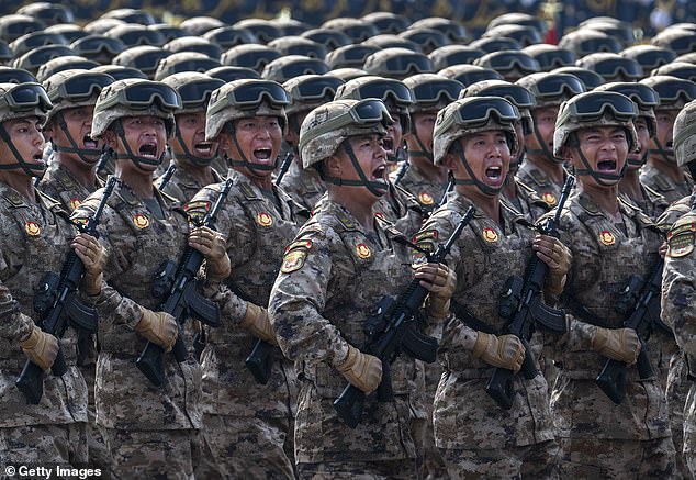 Chinese soldiers marching at a military parade in September. Senior military officials have allegedly been told to prepare for an invasion of Taiwan by 2027