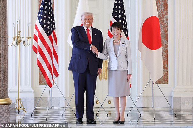 Donald Trump and Sanae Takiachi shake hands last month. A conflict between Japan and China will force the US to step in to defend Japan, according to experts