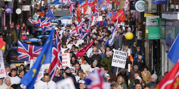 Hundreds protest against plans to house 600 migrants in army camp as young cadets face being forced out