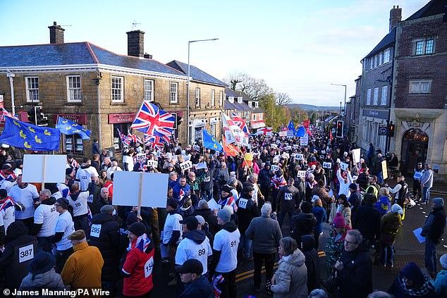 Today, six hundred marchers wore numbered bibs to highlight the number of asylum seekers expected to be housed at the site next week