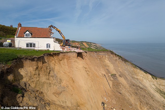 TRIMINGHAM: A farmhouse destined for the abyss is hastily demolished in 2024 due to rampant coastal erosion in Norfolk