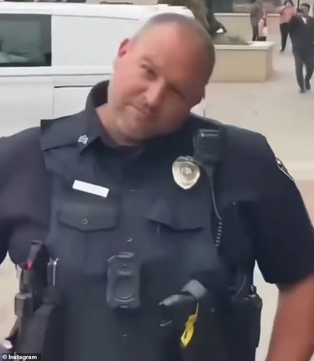 Just before being slammed in the head with the drink, the officer remained quiet and made faces at the protestors