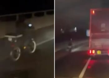 Watch moment delivery driver rides e-scooter down busy motorway as lorry spotted overtaking 'idiot' biker