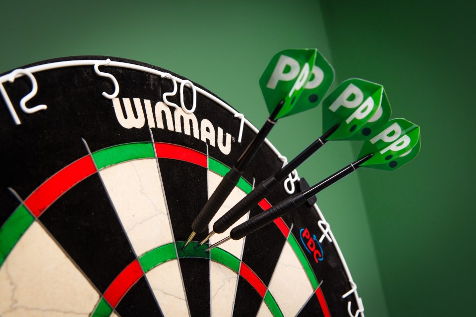 Three darts with green "PP" flights landed on the green ring of a dartboard.