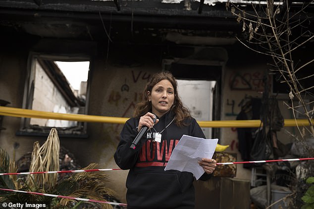 Amit Soussana, a former hostage, speaks to the press near her house where she was kidnapped during the October 7 attack on the kibbutz, on January 29, 2024, in Kfar Aza, Israel