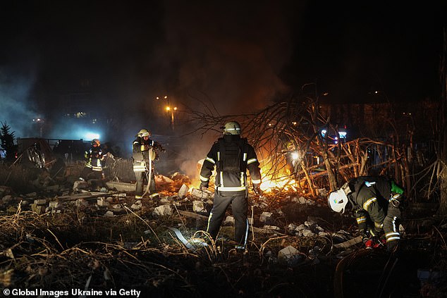 Rescue workers extinguish a fire at the site of a Russian drone strike on residential buildings in the Shevchenkivskyi district of the city on November 24, 2025 in Kharkiv, Ukraine