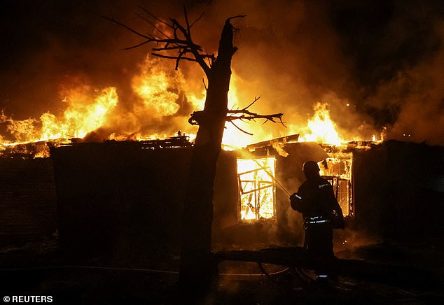 A firefighter works at the site of a Russia drone strike, amid Russia's attack on Ukraine, in Kharkiv, Ukraine November 23, 2025