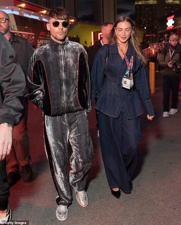 Sporting a distinctive velour tracksuit, Louis inevitably caught the eye as he made his way across the venue with Zara, who looked typically stylish in a blue denim co-ord