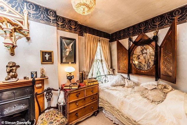 In the rear bedroom there is a walk-in closet and fireplace. Fascinating religious imagery also hangs on the walls