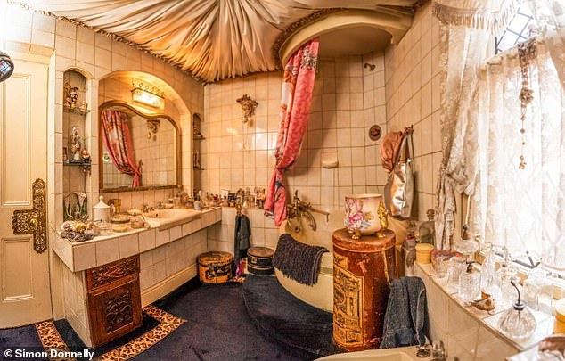 Keeping with the theme, a family bathroom features a corner bath and vanity unit with tiled surrounds