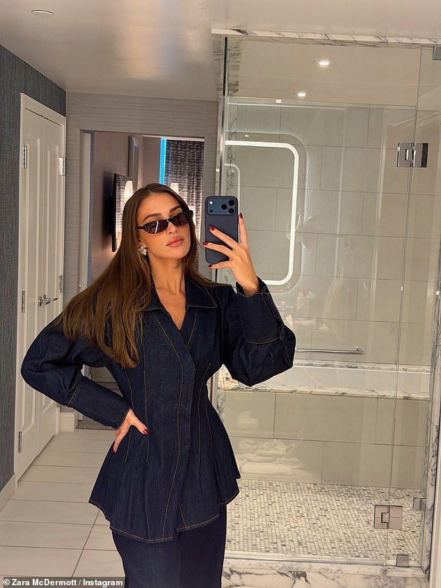 Posing up a storm in the hotel bathroom, the reality star showed off the cinched denim blazer and matching trousers co-ord she had worn to the F1