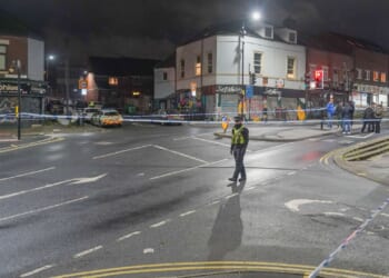 Boy, 16, fights for his life after being shot on popular shopping street as cops urgently investigate horror attack