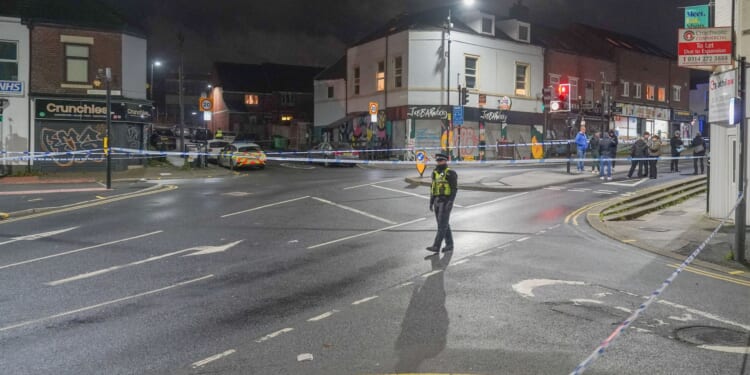 Boy, 16, fights for his life after being shot on popular shopping street as cops urgently investigate horror attack