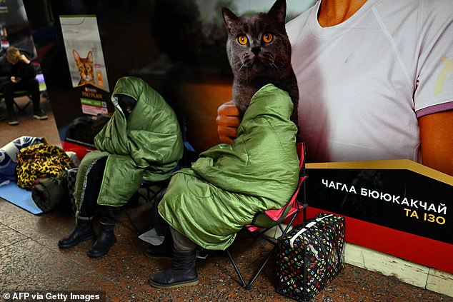People take shelter at a metro station during an air attack in Kyiv on November 25, 2025