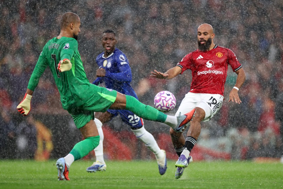 Chelsea goalkeeper Robert Sanchez fouls Manchester United's Bryan Mbeumo.