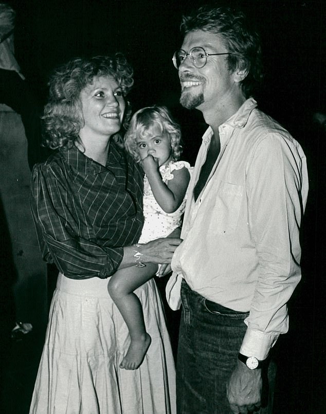 The couple pictured with daughter Holly. After finding out she worked at a nearby 'bric-a-brac shop' in Westbourne Grove, he set about wooing her
