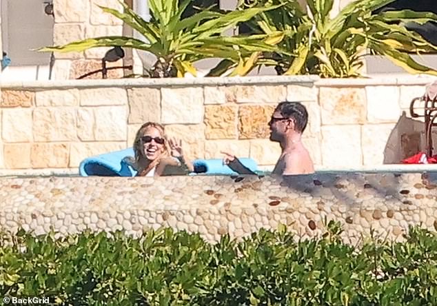 Sweeney flashed a joyful smile towards her boyfriend as she glided on a blue floatie