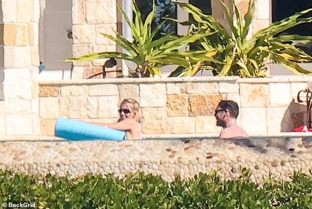 The hard-working star relaxed on her pool floatie