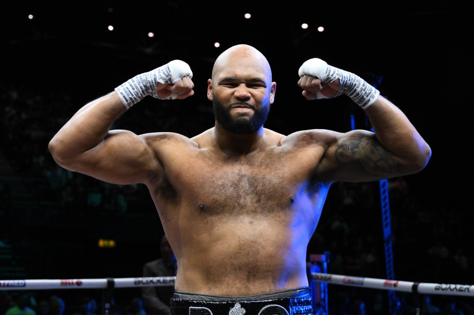 Frazer Clarke flexing his muscles after a boxing match.