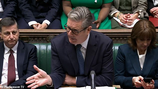 Ms Reeves can be seen reading the bad news as Prime Minister's Questions continues today