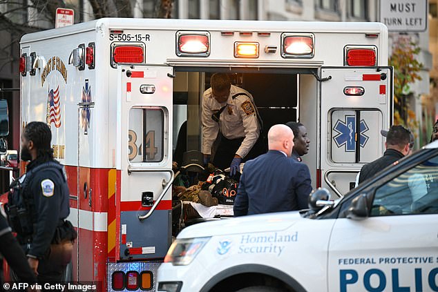An injured soldier was seen receiving medical attention inside an ambulance at the scene of the shooting