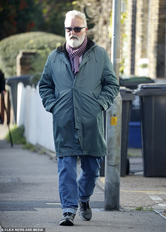 He completed his look with turned up jeans and trainers as he kept warm by keeping his hands in his pockets