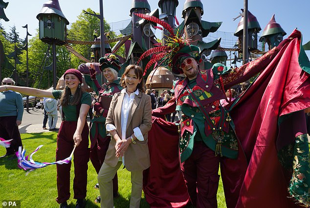 Jane Percy, Duchess of Northumberland, with characters from 'Lilidorei', the brand-new attraction located in the grounds of the Alnwick Garden in Northumberland in 2023