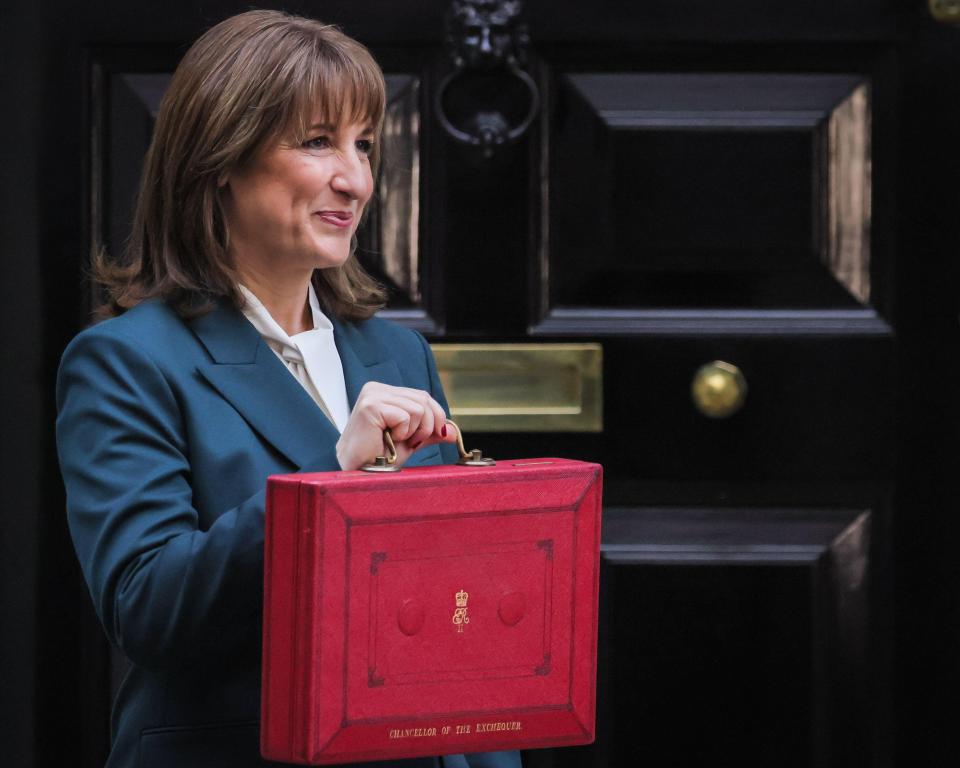 Rachel Reeves, UK Chancellor of the Exchequer, presents the red 'budget box' outside 11 Downing Street.