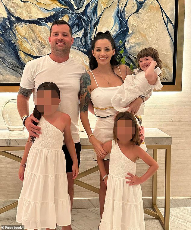 Christopher Scholtes (left) and his wife Dr Erika Scholtes, holding Parker in her arms, along with their two older daughters