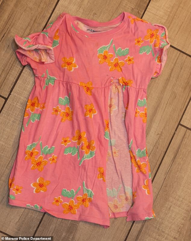 Another heartbreaking photo showed the small pink dress with flowers printed on it that Parker was wearing, laying on the kitchen floor and slashed open by paramedics