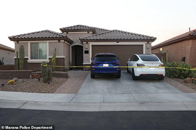 The blue Acura outside the house in Marana, Arizona, with Erika's white Tesla parked next to it