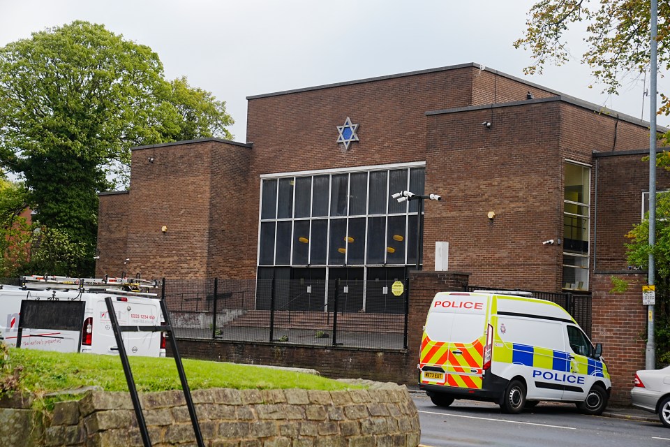 Heaton Park Hebrew Congregation synagogue in Manchester, with a police van parked outside.