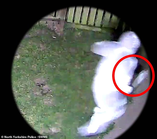 Pictured: One of the assailants chasing the victim with a machete style knife