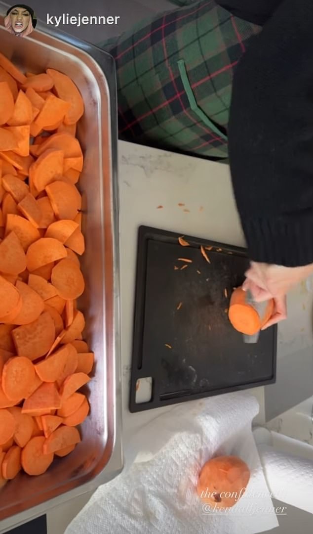 Kylie Jenner giggled as she took a video of her sister Kendall Jenner chopping a trayful of sweet potatoes, and captioned the clip: 'The confidence!'