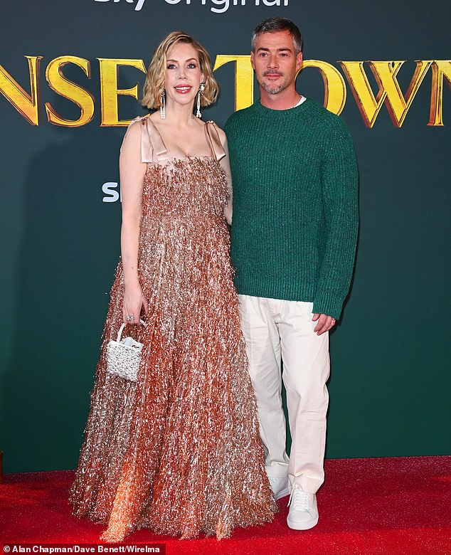 The comedian was all smiles as she posed with husband Bobby Kootstra, who looked festive in a green glittering jumper