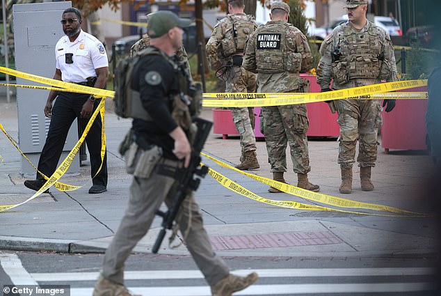 A member of law enforcement with a rifle at the scene near the White House