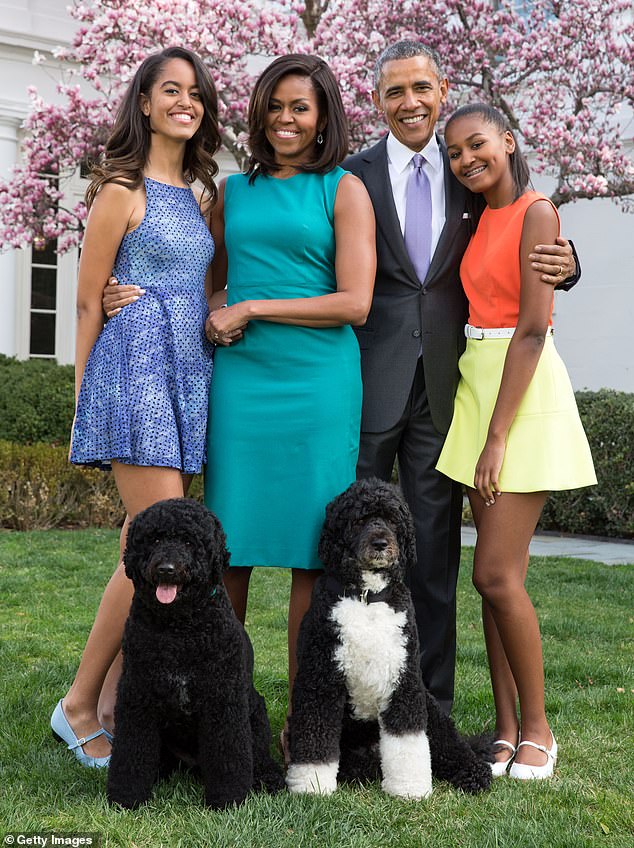 The family pose with their dogs Bo and Sunny in the White House Rose Garden in April 2015