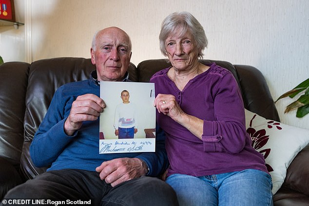 Eddy and Moira Ross, holding a photograph of their son, Michael