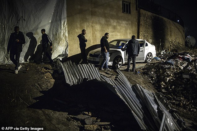People inspect the site of a reported shooting that left two Palestinians dead during a military operation in the occupied West Bank city of Jenin on November 27, 2025