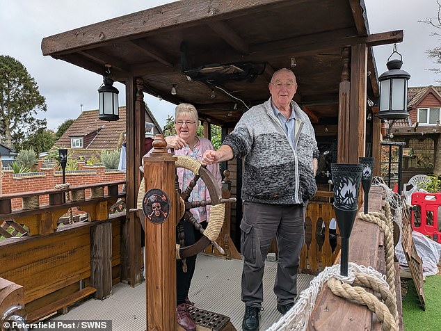 Steve Coombs' huge boat features a captain's hideout, a moving ship's wheel, netting, a cannon and other realistic features. Pictured: Steve and Lynnette Coombs with their self built pirate ship