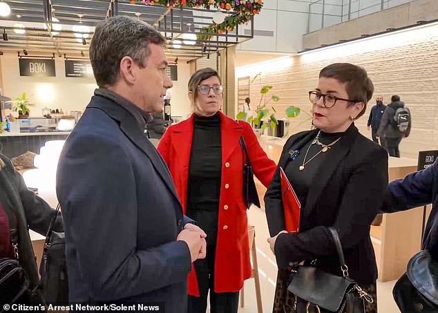 Mr Gosden attempts to reason with a woman who appears to be the ringleader of the all-female group