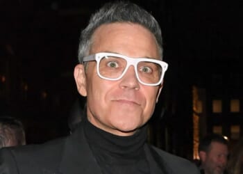Robbie Williams steps out in chunky white specs after claiming fat jabs are ruining his eyesight