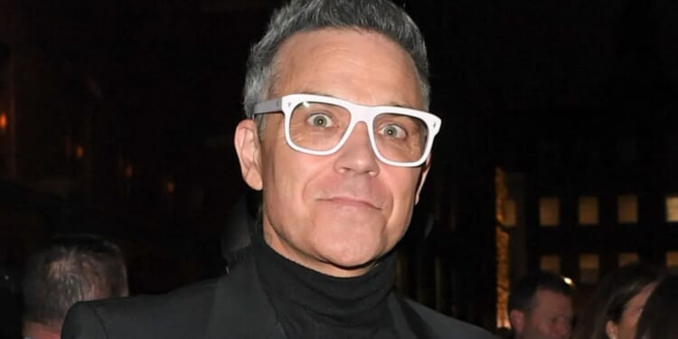 Robbie Williams steps out in chunky white specs after claiming fat jabs are ruining his eyesight