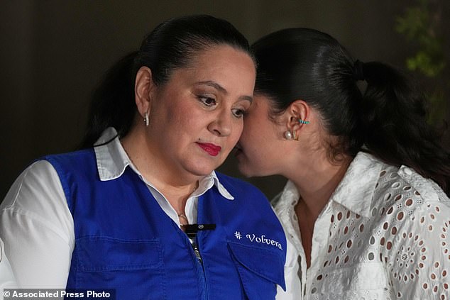 Ana García, left, wife of former Honduras' President Juan Orlando Hernández, listens to her daughter Daniela in Tegucigalpa, Honduras after hearing news of Trumps forthcoming pardon