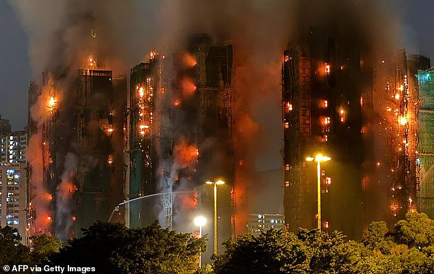 Thick smoke and flames rise as a major fire engulfs several apartment blocks at the Wang Fuk Court residential estate in Hong Kong's Tai Po district on November 26, 2025