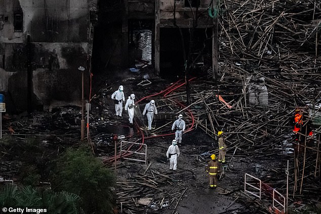 Disaster Victims Identification Unit work at the site following a fire at the Wang Fuk Court residential estate on November 28, 2025 in Hong Kong