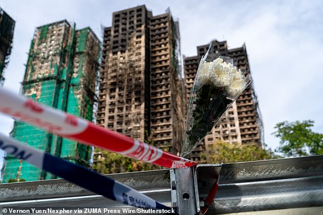 A bouquet of flowers near the buildings at the scene of where a major fire engulfed several residential buildings at Wang Fuk Court on November 28, 2025 in Hong Kong. Hong Kong Building Fire