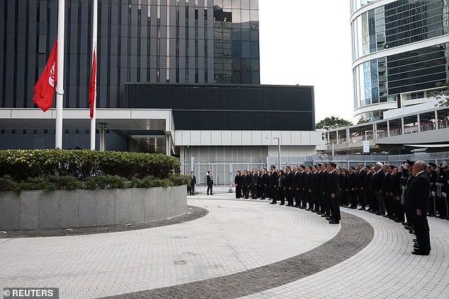 Officials attend a ceremony at Central Government Offices of Hong Kong to commemorate victims killed in the deadly fire
