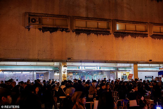 People gather at a volunteer camp in a courtyard, following the deadly fire at the Wang Fuk Court housing complex, Hong Kong, China, November 28, 2025